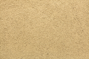 Yellow painted stucco wall. Background texture