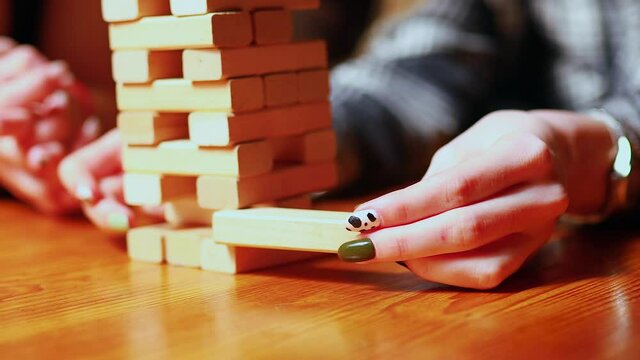 Authentic people Young people have fun playing board games at a table in cafe