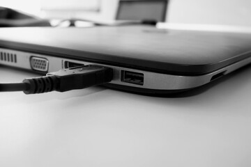 USB cable plugged in to laptop computer, close up