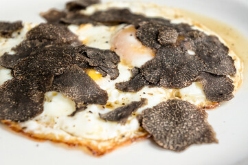 Fried eggs with truffle chips closeup - 416086891