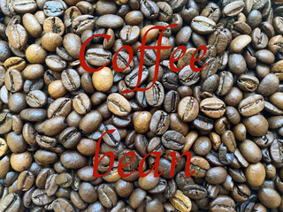 Coffee beans close-up in the background. The texture of the coffee bean