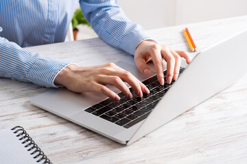 Close up business woman hands working at laptop