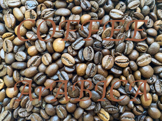 Coffee beans close-up in the background. The texture of the coffee bean
