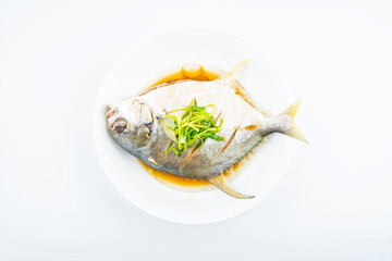 A dish of steamed jinchang fish on white background