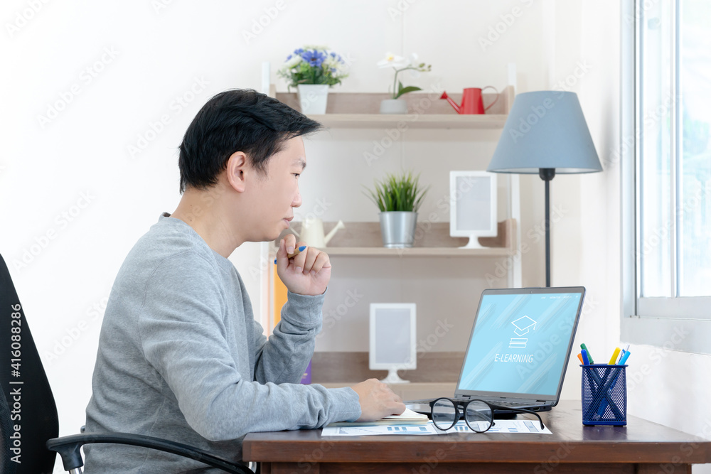 Poster e learning. casual business man writing on notebook and working on laptop computer in home. man stud