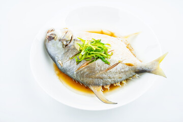A dish of steamed jinchang fish on white background