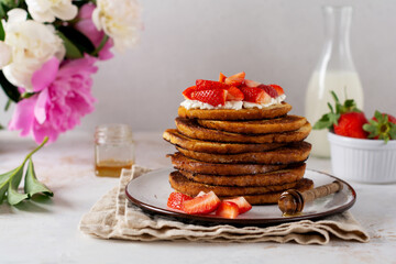 Stack of french toast with cottage cheese, honey and strawberries for breakfast. Selective focus