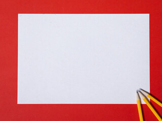 Three pencils on a red and white background. negative space for text, logos, images.