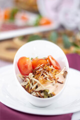 Salad with cherry tomatoes and  pie potatoes served in a restaurant style