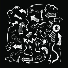 Obraz premium vector illustration. white directional arrows on a black background. hand drawing. doodle