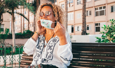 Young caucasian woman people wear medical protection mask for coronavirus contagion and covid-19...