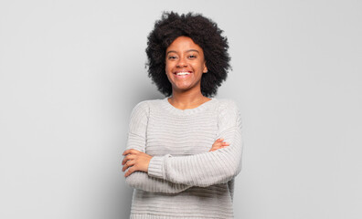  looking like a happy, proud and satisfied achiever smiling with arms crossed