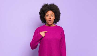  looking shocked and surprised with mouth wide open, pointing to self