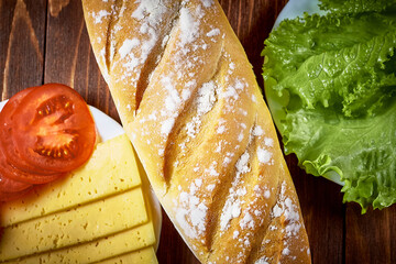 Ingredients for sandwich falling in the air isolated on white - slices of fresh tomatoes, ham, cheese and lettuce