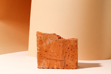 Beige bright brick podium tile on a beige background, natural background with hard shadow for your...