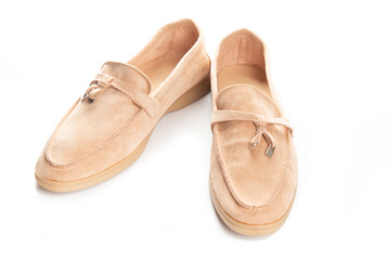 Pair of beige modern unisex loafers on white background