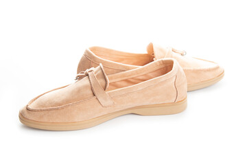 Pair of beige modern unisex loafers on white background