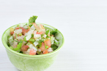 Sauces and dressings for Mexican food in bowls on white wooden background