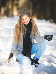 Happy teenage girl playing in snow and enjoying sunny winter day stock photo