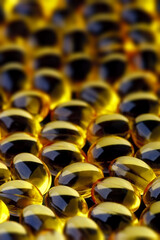 Fototapeta premium Fish oil concentrate in a soft gelatin capsule to support human health. Close-up Omega3 with selective focus and shallow depth of field.