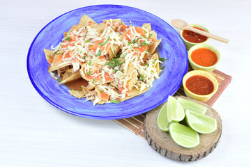 Traditional Mexican food in beautiful marbled colored plates on white wooden background