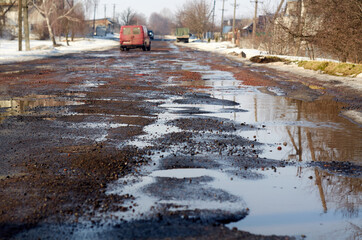 Destroyed asphalt road after winter