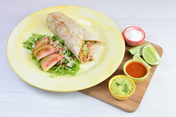 Traditional Mexican food in beautiful marbled colored plates on white wooden background