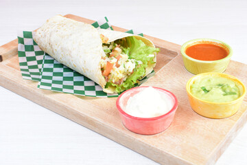 Traditional Mexican food in beautiful marbled colored plates on white wooden background