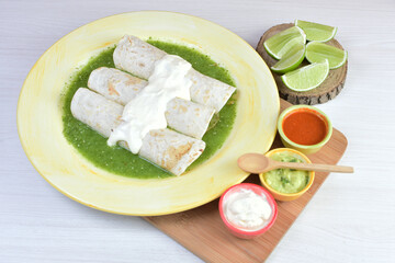 Traditional Mexican food in beautiful marbled colored plates on white wooden background