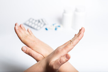 Bad pills and drugs. Hands showing stop for pills and medicines.