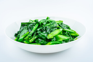 A dish of fried kale on white background