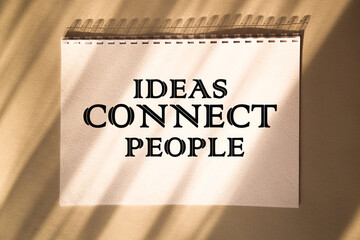 IDEAS CONNECT PEOPLE. Saying. expression written on a notepad