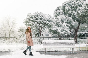Cheerful woman walking in winter park