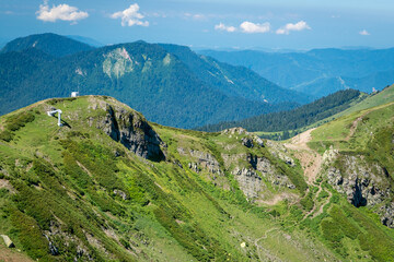 Fototapeta na wymiar Summer landscapes of the Caucasus mountains in Rosa Khutor, Russia, Sochi, Krasnaya Polyana. Peak 2320m
