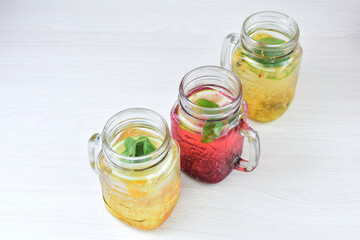 Colorful drinks, Italian sodas with ice, fruit flavors on white wooden background