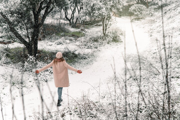 Unrecognizable woman walking in winter woods