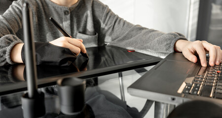 teenage girl using digital graphic tablet and drawing pen for new picture. Online education drawing lesson. Blogging