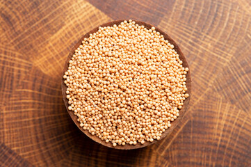 Bowl of Mustard Seeds on a Butcher Block