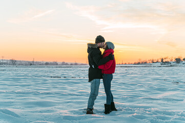 Couple kissing in snowy field