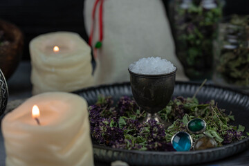 Magic altar with mystical herbs, salt, candles and crystals. Witch sanctuary sacred esoteric concept.