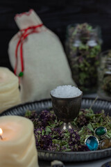 Magic altar with mystical herbs, salt, candles and crystals. Witch sanctuary sacred esoteric concept.
