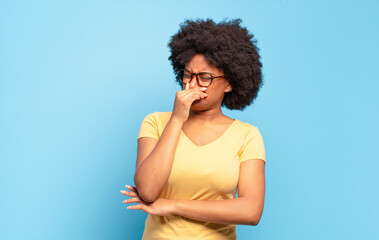  feeling disgusted, holding nose to avoid smelling a foul and unpleasant stench