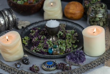 Obraz na płótnie Canvas Magic altar with mystical herbs, salt, candles and crystals. Witch sanctuary sacred esoteric concept.