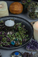 Magic altar with mystical herbs, salt, candles and crystals. Witch sanctuary sacred esoteric concept.