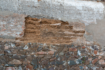 old stone wall collapsing