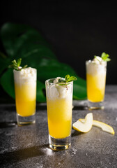 Photo for bar concept or magazines. Glasses of melon drink on dark background. Fresh and summer drink. laid out in layers with whipped cream