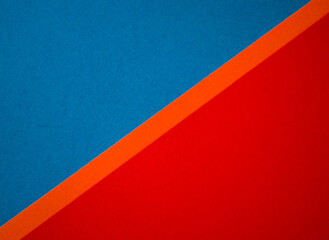 Blue , red and orange diagonally divided colored paper textured background