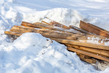 Heap of long wooden boards for the construction and improvement of the yard