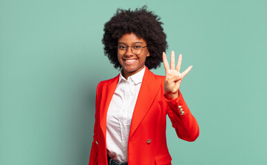  smiling and looking friendly, showing number four or fourth with hand forward, counting down