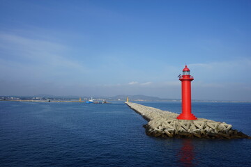 Fototapeta na wymiar The red lighthouse on the beach.